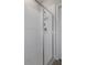 Close up of the modern shower with white subway tiles, rainfall shower head, glass doors, and hexagon flooring at 9817 Coneflower Ct, Land O Lakes, FL 34637