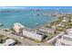 A beautiful aerial view of the condo complex overlooking the ocean with sailboats in the distance at 100 Bluff View Dr # 614A, Belleair Bluffs, FL 33770