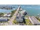 Aerial view of waterfront condos with a pool and boat access and a bridge at 100 Bluff View Dr # 614A, Belleair Bluffs, FL 33770
