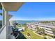 Scenic view from balcony overlooking pool, manicured lawn, and bay at 100 Bluff View Dr # 614A, Belleair Bluffs, FL 33770