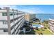 Elevated view of building with bay access, pool, and beautiful lawn at 100 Bluff View Dr # 614A, Belleair Bluffs, FL 33770