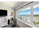 Bedroom area with a large window offering city views, complemented by neutral tones and modern decor at 100 Bluff View Dr # 614A, Belleair Bluffs, FL 33770