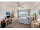 Bright bedroom with water views, a desk area, and coastal-themed decor at 100 Bluff View Dr # 614A, Belleair Bluffs, FL 33770