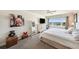 Well-lit bedroom featuring light walls, plush carpet, and a serene water view at 100 Bluff View Dr # 614A, Belleair Bluffs, FL 33770
