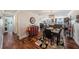 View of the dining room featuring hardwood floors, decorative rug, and access to the kitchen at 100 Bluff View Dr # 614A, Belleair Bluffs, FL 33770