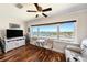 Bright living room space with beautiful hardwood floors, a large window, and comfortable furniture at 100 Bluff View Dr # 614A, Belleair Bluffs, FL 33770