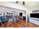Large living room with hardwood floors features an open-concept design with a partial view of the kitchen at 100 Bluff View Dr # 614A, Belleair Bluffs, FL 33770