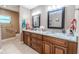 Bathroom featuring double vanity with granite countertop, modern fixtures and a window at 10100 Grove Dr, Port Richey, FL 34668