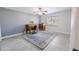 Bedroom with a large window, light blue walls, area rug, and furniture at 10100 Grove Dr, Port Richey, FL 34668