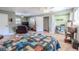 Spacious bedroom with bed, TV, seating, a view of the closet and doorway at 10100 Grove Dr, Port Richey, FL 34668