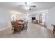 Large dining room leading to living spaces featuring a ceiling fan at 10100 Grove Dr, Port Richey, FL 34668