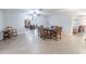 Dining room area leading into the kitchen and other living spaces, with tile floors at 10100 Grove Dr, Port Richey, FL 34668