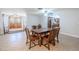 Traditional dining room with tiled floor, wooden table and chairs, with access to kitchen at 10100 Grove Dr, Port Richey, FL 34668