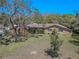 Charming single-story home with stone facade, mature landscaping, and a well-maintained lawn at 10100 Grove Dr, Port Richey, FL 34668