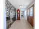 Grand foyer entry with tile flooring, wood double doors, and decorative mirror at 10100 Grove Dr, Port Richey, FL 34668