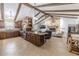 Open kitchen and living area with stone fireplace, modern appliances, and custom cabinetry at 10100 Grove Dr, Port Richey, FL 34668