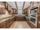 Gourmet kitchen showcasing granite countertops, custom cabinets, and stainless steel appliances at 10100 Grove Dr, Port Richey, FL 34668