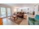 Comfortable living room with tile floor and a view of the patio and outdoor space at 10100 Grove Dr, Port Richey, FL 34668