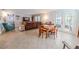 Open-concept living room with tile flooring, a large sectional, and a dining table at 10100 Grove Dr, Port Richey, FL 34668