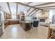 Open concept living space featuring a stone fireplace, vaulted ceiling, and adjoined kitchen at 10100 Grove Dr, Port Richey, FL 34668