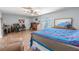 Large primary bedroom with wood floors, ceiling fan, and workspace at 10100 Grove Dr, Port Richey, FL 34668