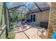 Enclosed patio area with seating, overhead screen and stone accents at 10100 Grove Dr, Port Richey, FL 34668