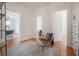 Hallway featuring hardwood floors, a chair, and multiple doorways at 1014 E Clifton St, Tampa, FL 33604