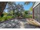 Well-maintained yard featuring a concrete patio, large oak tree, and lush landscaping at 1014 E Clifton St, Tampa, FL 33604