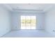 Bright bedroom featuring recessed lighting and large glass sliding doors at 10385 Winnipeg St, Port Charlotte, FL 33981