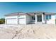 New construction home with a two-car garage and a modern front entrance at 10385 Winnipeg St, Port Charlotte, FL 33981