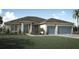 Charming single-story home with a well-manicured lawn and a two-car garage at 10385 Winnipeg St, Port Charlotte, FL 33981