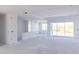 Bright living room boasts recessed lighting, open layout, and sliding glass doors to the backyard at 10385 Winnipeg St, Port Charlotte, FL 33981