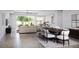 Bright open-concept living room with hardwood floors and a view of the backyard at 10385 Winnipeg St, Port Charlotte, FL 33981