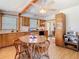 Traditional kitchen with natural wood cabinets, light countertops, black appliances and a view to the breakfast nook at 10402 N Boulevard, Tampa, FL 33612