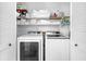 This laundry room features white appliances and shelving at 11722 Currie Ln # B3, Largo, FL 33774