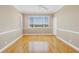 Bright bedroom with large window, hardwood floors, and ceiling fan at 1196 Gandy Crest Ne Dr, St Petersburg, FL 33702