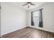 Bright bedroom features wood-look floors, ceiling fan, and window with stylish curtains at 13001 Satin Lily Dr, Riverview, FL 33579