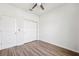 This bedroom features sleek wood-look floors and white closet with sliding doors at 13001 Satin Lily Dr, Riverview, FL 33579