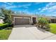 Charming single-story home featuring a well-manicured lawn and attached two-car garage at 13001 Satin Lily Dr, Riverview, FL 33579