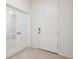 Entryway showcasing the front door, French doors, and tile flooring, offering a welcoming entrance at 13001 Satin Lily Dr, Riverview, FL 33579