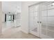 Hallway with a view to the open-concept living area with tile flooring and natural light at 13001 Satin Lily Dr, Riverview, FL 33579