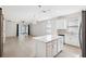 Open-concept kitchen with a center island, leading to a spacious living area with sliding glass doors at 13001 Satin Lily Dr, Riverview, FL 33579