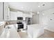 Bright kitchen features stainless appliances, white cabinets, quartz counters, and a convenient center island at 13001 Satin Lily Dr, Riverview, FL 33579