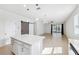 Open kitchen with center island featuring a barn door and open floor plan to the living room and access to the backyard at 13001 Satin Lily Dr, Riverview, FL 33579