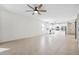Open floor plan featuring tile flooring, a ceiling fan, and access to the modern kitchen at 13001 Satin Lily Dr, Riverview, FL 33579