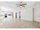 Wide view of kitchen and living area with sliding barn door and tiled floor at 13001 Satin Lily Dr, Riverview, FL 33579