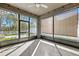 Enclosed sunroom with large windows, ceiling fan, and view to the outdoors at 13001 Satin Lily Dr, Riverview, FL 33579