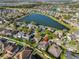Aerial view featuring a house with a screened pool and a lake view at 13719 Artesa Bell Dr, Riverview, FL 33579