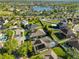 Aerial view of homes surrounding a lake with green spaces at 13719 Artesa Bell Dr, Riverview, FL 33579
