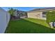 Well-maintained backyard featuring green grass and a screened-in pool area for outdoor enjoyment at 13719 Artesa Bell Dr, Riverview, FL 33579